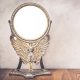 Old antique vintage cast iron desk makeup mirror frame blank holds on the stand in the form of goddess with wings or angel standing on table. Circa end of 1800s or early 1900s. Retro style filtered